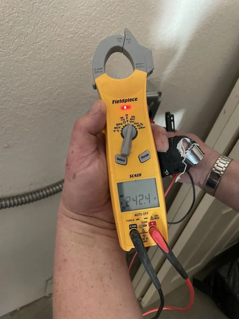 Voltage testing with clamp meter during Recessed Lighting Installation in Putnam